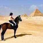 Tourists enjoying a Quad Bike and Horse Ride around the Giza Pyramids in Egypt