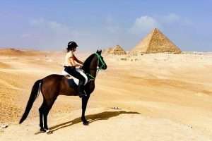Tourists enjoying a Quad Bike and Horse Ride around the Giza Pyramids in Egypt