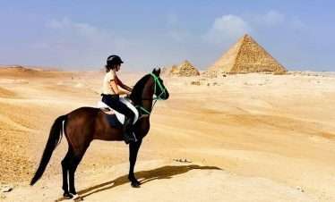 Tourists enjoying a Quad Bike and Horse Ride around the Giza Pyramids in Egypt