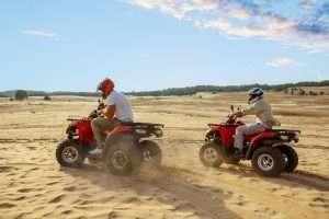 Tourist riding quad bike near Giza Pyramids during Breeze Quad tour