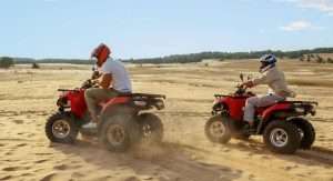 Tourist riding quad bike near Giza Pyramids during Breeze Quad tour