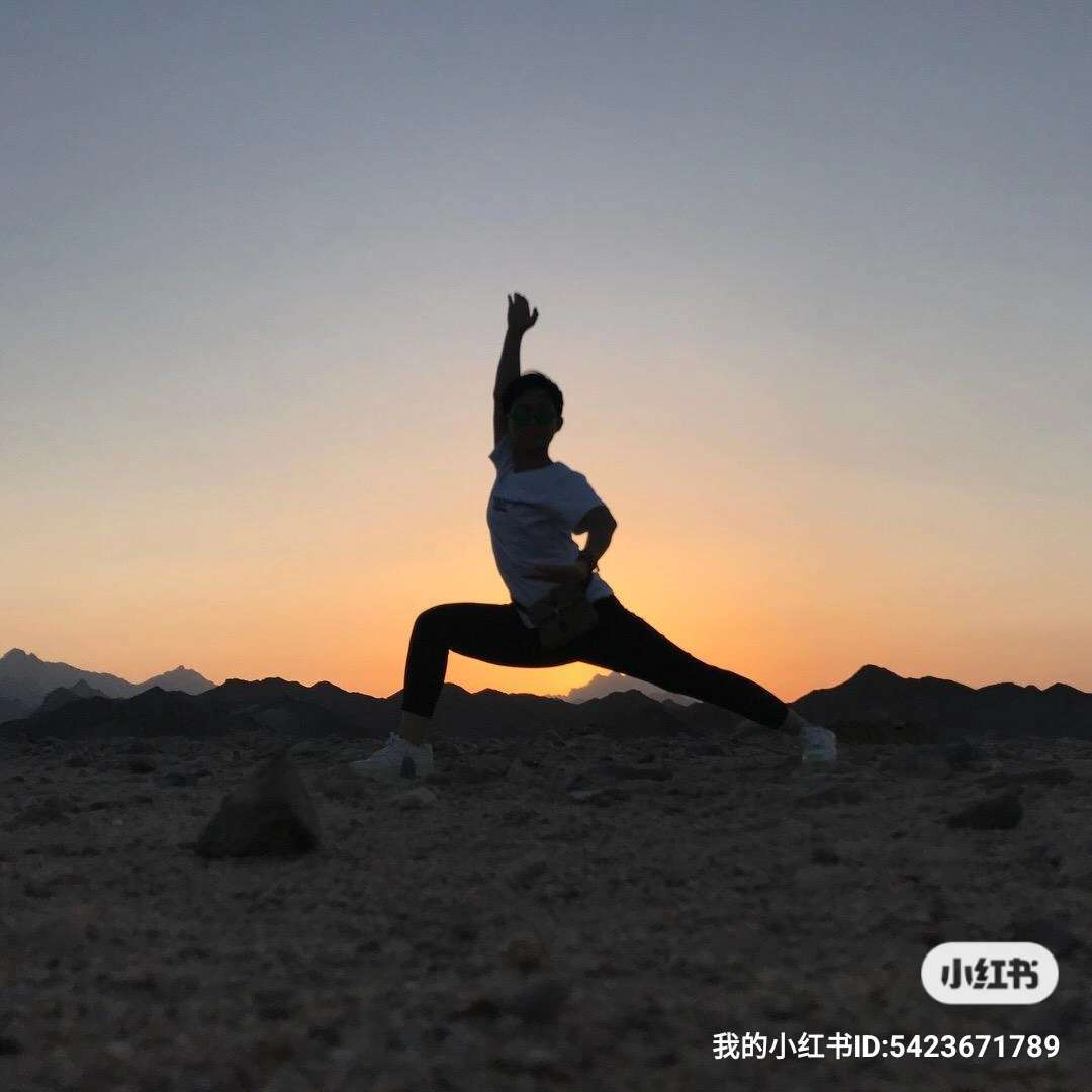Dynamic silhouette of a person practicing yoga against the Giza Pyramids during sunset, showcasing Egypt tours and desert exploration. Perfect for adventure seekers eager to experience Egypt's iconic landmarks.