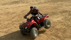 ATV rider crossing the Giza desert with panoramic views of the pyramids in Egypt